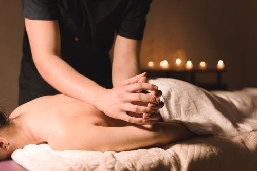 woman giving a back massage
